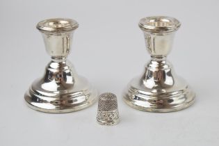 A pair of silver short candlesticks, Birmingham 1961, loaded bases, with a sterling silver