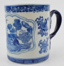 A large oversized oriental blue and white tankard, with ornate handle, character mark to base,