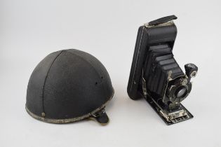 A Slazenger Made in England Motorcycle helmet together with a vintage Kodak camera. (2) Helmet in