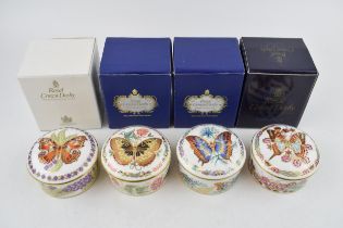 A set of four Royal Crown Derby Butterflies of The World circular trinket pots and covers,