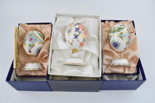 Three Royal Crown Derby Eggs of the World on stands, 2 x Russia pattern and a Japan pattern. each