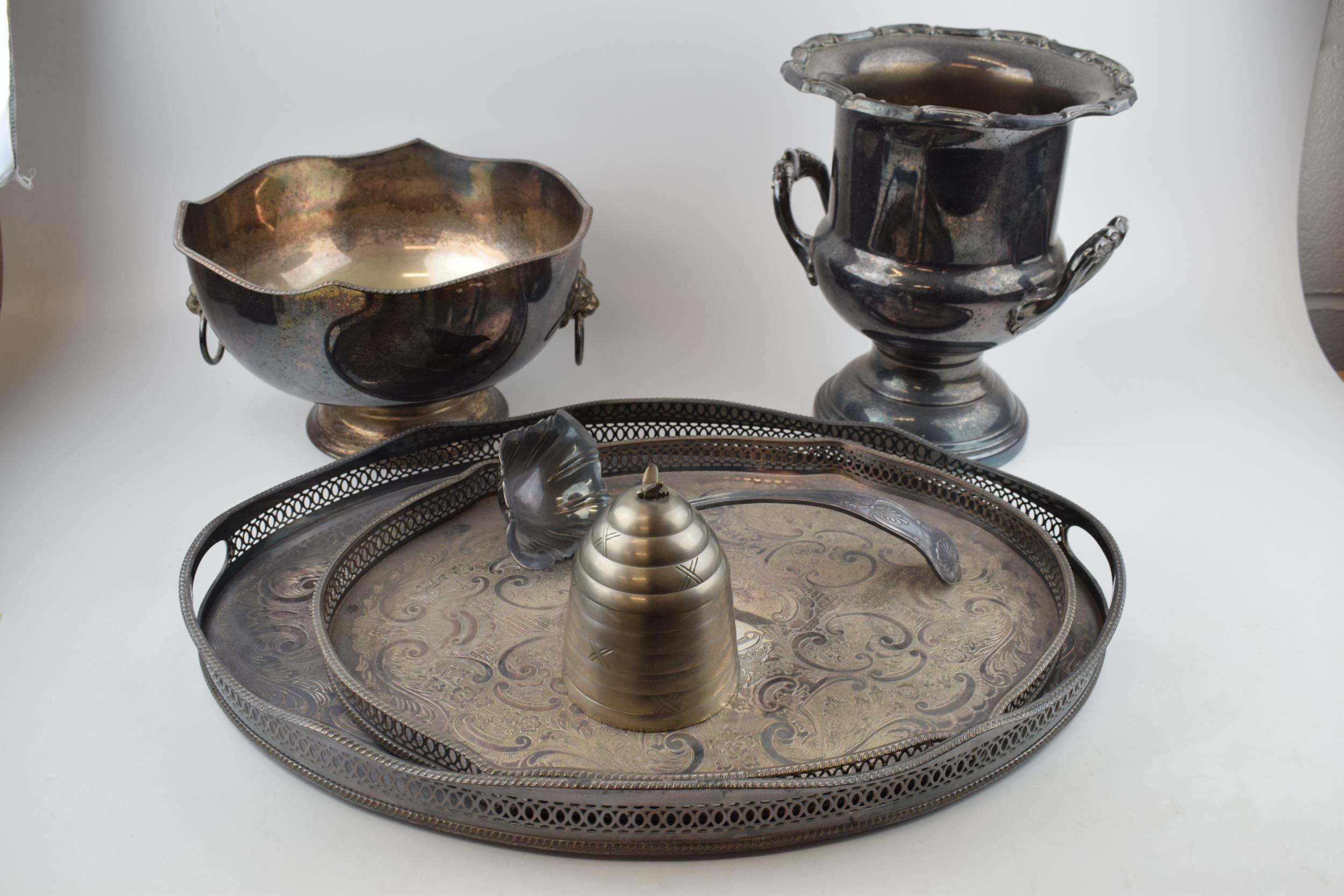 A collection of silver-plated items to include trays, an urn and a bowl, largest 27cm tall. In - Image 2 of 5