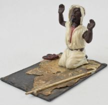 A vintage novelty hand-painted spelter model of a man knelling of prayer mat. Sprung head. Baes