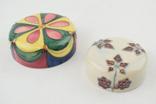 A pair of Moorcroft paperweights / pot lids with bright coloured designs (2), 11cm diameter. In good