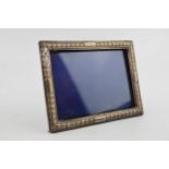 A silver photo frame, Hallmarked London 1892. With purple velvet back. Original stand and glass.