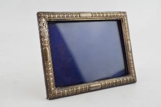 A silver photo frame, Hallmarked London 1892. With purple velvet back. Original stand and glass.