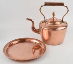 An antique copper kettle, height 28cm, together with a copper tray, diameter 25.5cm (2) In good