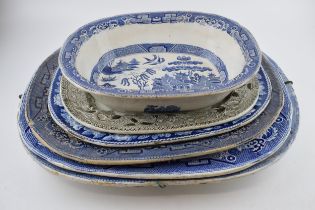 A group of 19th century blue and white pottery Willow pattern platters and other similar. (q)