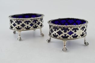 A pair of silver table salts, with blue glass liners, London 1900, 123.7 grams (2). Chips to one