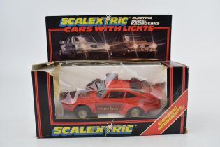 A boxed vintage Scalextric C.427 Red Porsche Turbo with working head and brake lights. Model in