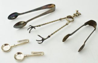 A continental 800 silver pair of sugar claws with goat finial, 18.2 grams, a pair of silver sugar