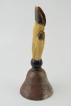 An antique bell with taxidermy deer's hoof handle set in ebonized turned mount. Height 20cm. In good