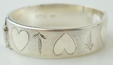 Hallmarked silver wide bangle, Birmingham 1970, 30.0 grams, with hearts and floral decoration,