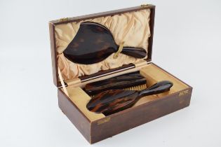 Vintage tortoiseshell vanity set to include, brush, mirror, comb and flat brush in leather case with