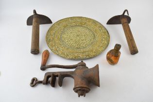 Two antique wrought iron pig scrapers / butchers tools together with a mincer and a brass charger
