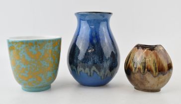Poole Pottery vases to include a bulbous vase in blue glaze, a similar short vase in blue and orange