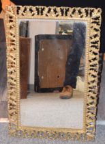 An antique style brass framed mirror. 43cm x 67cm. In good condition.