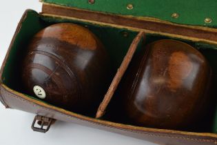 A set of vintage lignum vitae bowl in original leather carry case. Bowls in good original condition.