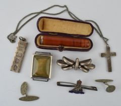 A collection of silver items to include watch case, cross on chain, brooch and other similar items.