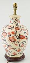 A Wade lamp base in a country house style with floral decoration in red / orange and blue with