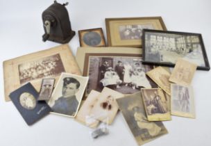 A mixed collection of items to include antique photographs, antique photo frames, a desk pencil