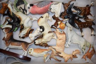 A collection of pottery to include Beswick animals such as a deer, a cockatoo, a corgi and others (