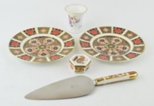 A collection of Royal Crown Derby items to include two 16cm diameter Imari pattern plates, a cake