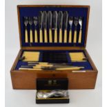 A silver-plated cutlery service in a golden oak canteen by George Butler & Co Sheffield.