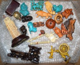 A collection of carved miniature oriental items to include netsukes and miniature figures in wood,