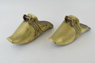 A pair of chinese style brass stirrups. Length 29cm, height 12cm.