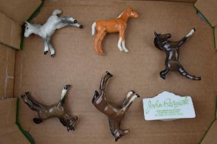 A collection of Beswick foals to include brown, grey and palomino colourways with a Beswick point of