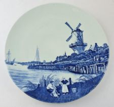 A Delft pottery transfer printed wall plate depicting windmill scene. Diameter 31cm. In good