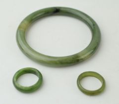 Two jade rings sizes O and P together with a jade bangle. (3) Weight 42.8 grams. In good original