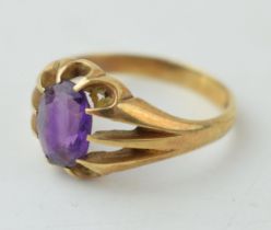 A gentleman's ring set with purple stone. Ring size Q. Gross weight 3.8 grams.