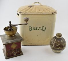 An original vintage enamel bread bin with green writing together with a studio pottery stoneware