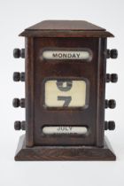 Early 20th century wooden perpetual calendar with scrolls to include days of the week, dates and