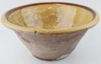 An antique English dairy bowl with cream / brown salt glaze. Diameter 40cm. Height 19cm. In good