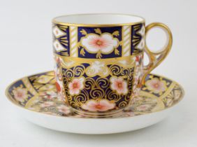An Edwardian Royal Crown Derby bone china moustache cup and saucer in Imari pattern (2). In good