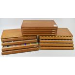 A set of three watchmakers drawers each containing four drawers containing small plastic cases for