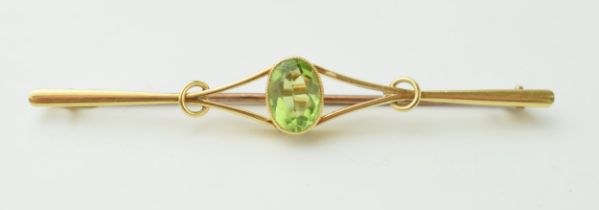 15ct gold Edwardian bar brooch set peridot, 4.9 grams, 6.5cm wide.