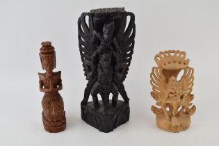 Three carvings of deities from Bali. In different woods. (3) Height 25cm.