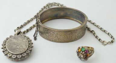 A collection of Victorian silver items to include a bangle a locket with bird motif on chain and a