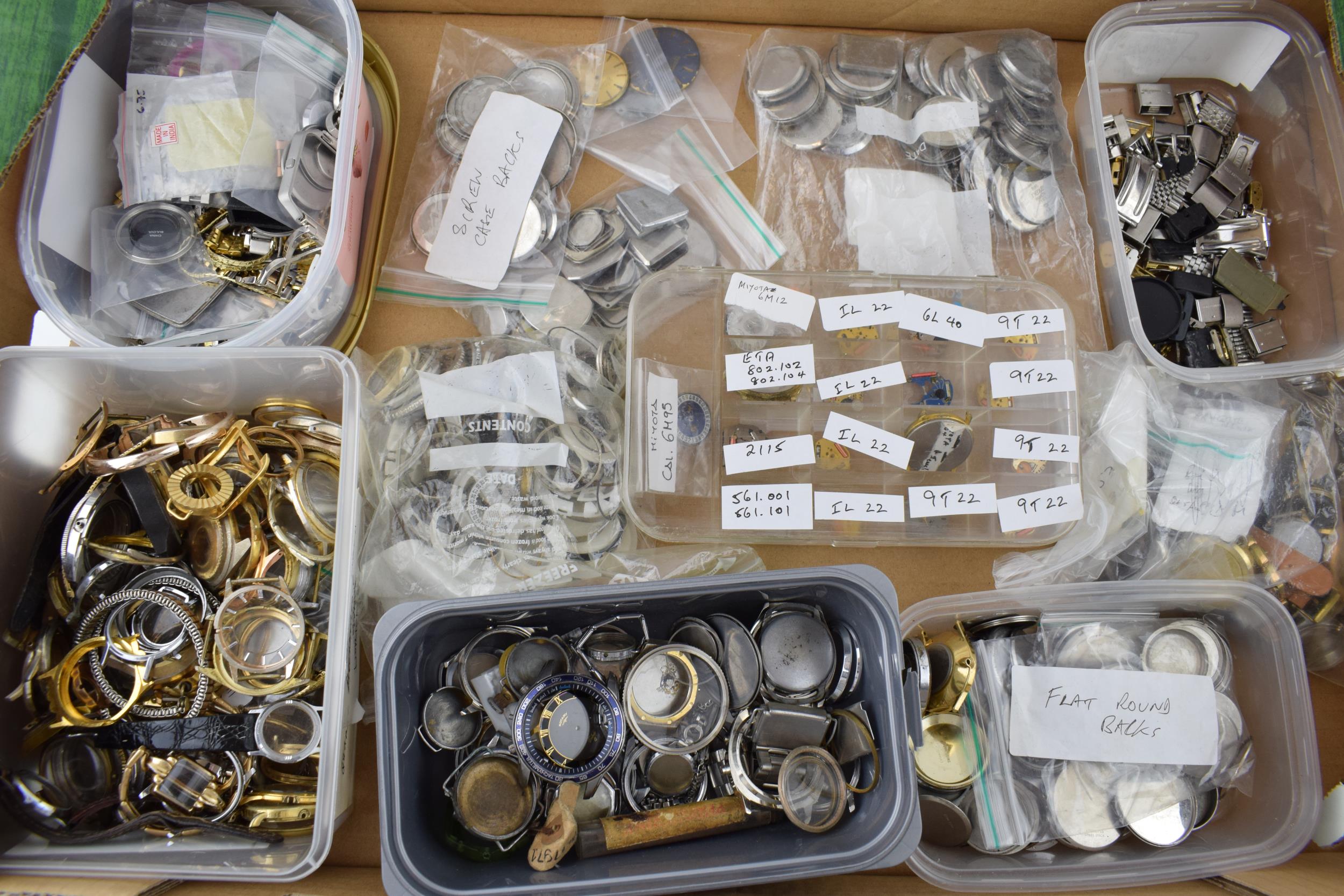 A large collection of watch parts to include bezels, quartz movements, watch backs and links. A good