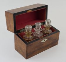 A 19th century boxed scent bottle holder with three original glass bottles with stoppers. Red velvet