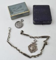 An antique silver fancy link Albert chain, two silver fobs, one of musical interest, together with