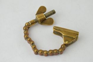 Antique brass novelty bottle top remover, tension and screw type movement, 14cm long.