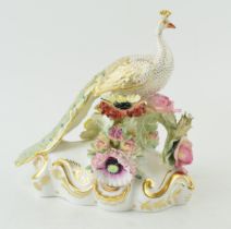 Royal Crown Derby figure of a perching peacock. In good condition with no obvious damage or