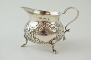 Silver embossed small jug, claw feet, Sheffield 1898, 58.6 grams, 8cm wide.