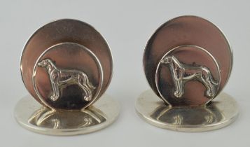 A pair of hallmarked silver menu holders / place setting holders, with whippets / greyhounds, London