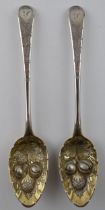 A pair of large Georgian silver spoons with embossed fruit decoration bowls, 144.4 grams, London